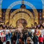 Plaza Mayor Christmas Market in Madrid with glowing arches and artisan stalls.