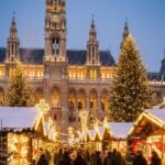 Vienna Rathausplatz Christmas Market with gothic buildings and glowing stalls.
