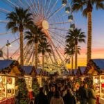 Wonderland Lisboa Christmas festival with ferris wheel, lights, and festive holiday stalls.