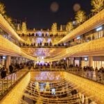 Osaka Namba Parks illuminated with cascading holiday lights and festive crowds.