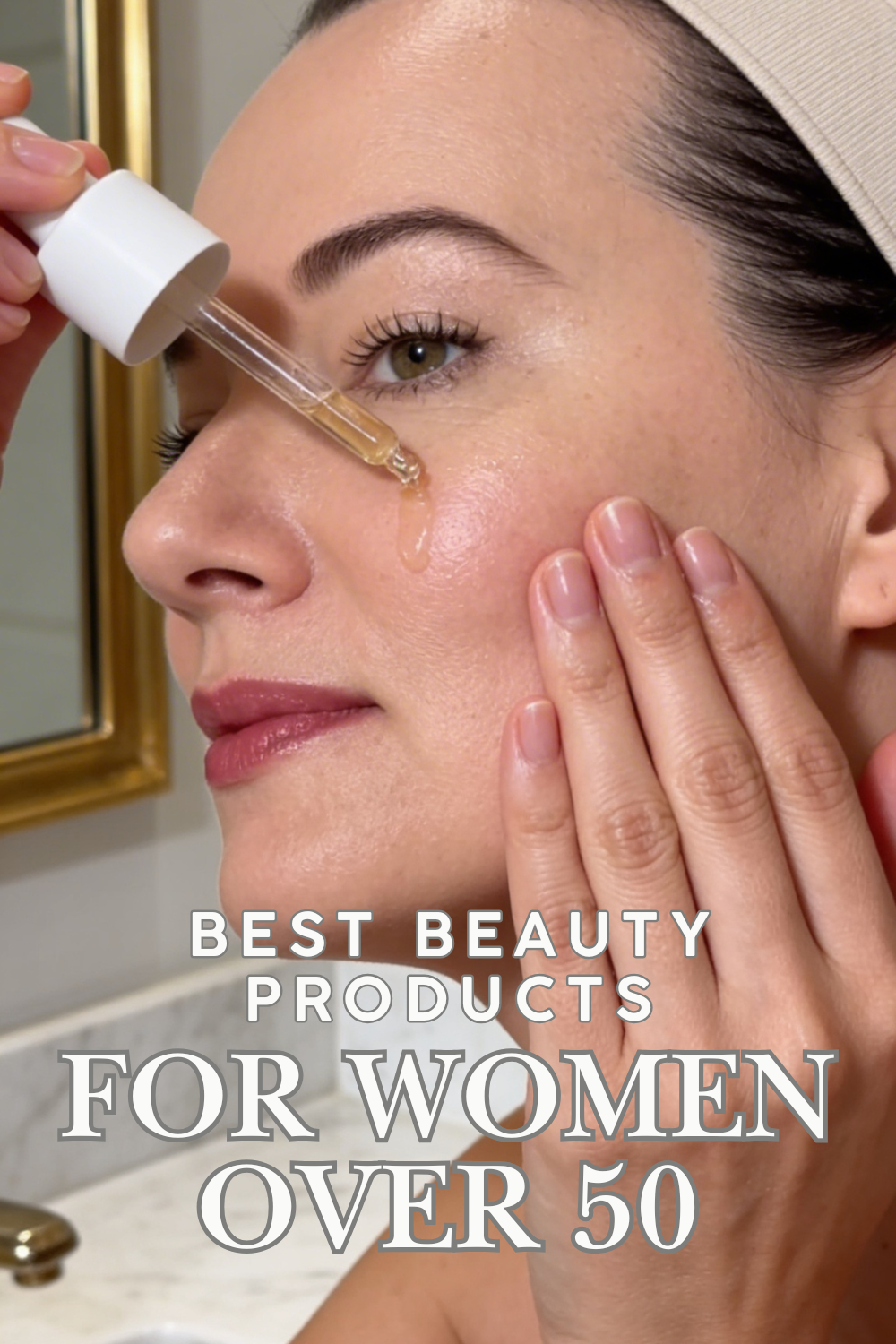 Close-up of a woman applying serum to her face with a dropper, text overlay says best beauty products for women over 50.