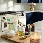 Vanilla sugar scrub ingredients styled on a white quartz counter in a dark blue and gold luxury farmhouse kitchen.