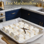 Finished vanilla bean sugar-free marshmallows arranged neatly on parchment paper.