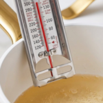 Candy thermometer reading 235–240°F in a saucepan of bubbling sugar-free syrup.