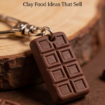 Mini chocolate bar keychain made from polymer clay resting on a wooden surface.