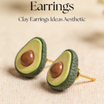 Realistic avocado stud earrings made from polymer clay with textured green skin and brown seed detail.