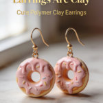 Mini pink frosted donut earrings made from polymer clay with sprinkle detail.