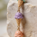 Gold bracelet featuring miniature pastel ice cream cone charms made from polymer clay.