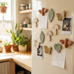 Retro cream refrigerator decorated with handmade clay magnets shaped like mushrooms, leaves, butterflies, and bees in a warm sunlit kitchen.