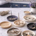 Handmade clay incense holders and small decorative dishes with botanical and moon details styled on a white quartz countertop in a bright kitchen.