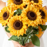 Woman in a white dress holding a large bouquet of oversized crocheted sunflowers with textured yellow petals and dark brown centers against a clean white background