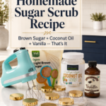 Pinterest pin with bold text reading The Best Homemade Sugar Scrub Recipe over a photo of ingredients including brown sugar, coconut oil, and vanilla extract with gold-lidded jars and an aqua hand mixer on a white quartz countertop