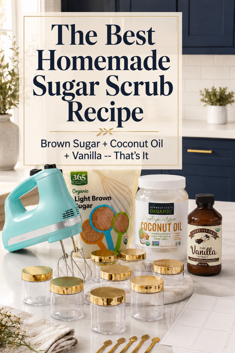 Pinterest pin with bold text reading The Best Homemade Sugar Scrub Recipe over a photo of ingredients including brown sugar, coconut oil, and vanilla extract with gold-lidded jars and an aqua hand mixer on a white quartz countertop