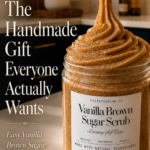 Pinterest pin with text reading The Handmade Gift Everyone Actually Wants over a photo of a Vanilla Brown Sugar Scrub jar from spiritedmind.co being piped on a marble countertop with navy and gold kitchen behind it