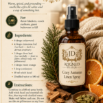 Amber glass fine mist spray bottle labeled Cozy Autumn Linen Spray by Aligned Design surrounded by cinnamon sticks, sliced oranges, cardamom pods, cloves, and cedar foliage against a warm cozy autumn background. Recipe infographic with cedarwood, cinnamon leaf, clove bud, sweet orange, and cardamom essential oils in a witch hazel base. One of 10 room-by-room essential oil linen spray recipes.