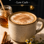 Ceramic mug of cinnamon honey jasmine latte with frothed milk and cinnamon dusting, star anise and cinnamon stick on white quartz, fresh chamomile and lavender beside mug, cozy low carb jasmine latte recipe