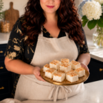 Woman holding a plate of low carb toasted coconut marshmallows in a farmhouse kitchen, sugar free keto dessert