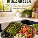 Prosciutto and mozzarella bento with roasted asparagus and balsamic glaze.