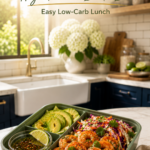 Shrimp bento box with avocado, cabbage slaw, cilantro, and lime in a compartment lunch box.