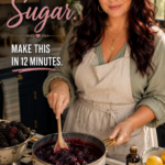 A woman with long dark hair in a sage green top and apron stirs a saucepan of blackberry sauce on the stove in a farmhouse kitchen with fresh blackberries and lemons nearby. Text overlay reads Skip the Sugar, make this in 12 minutes.