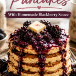 A tall stack of golden pancakes topped with butter and homemade blackberry sauce dripping down the sides, surrounded by fresh blackberries on a rustic wooden table. Text overlay reads Upgrade Your Pancakes with homemade blackberry sauce.