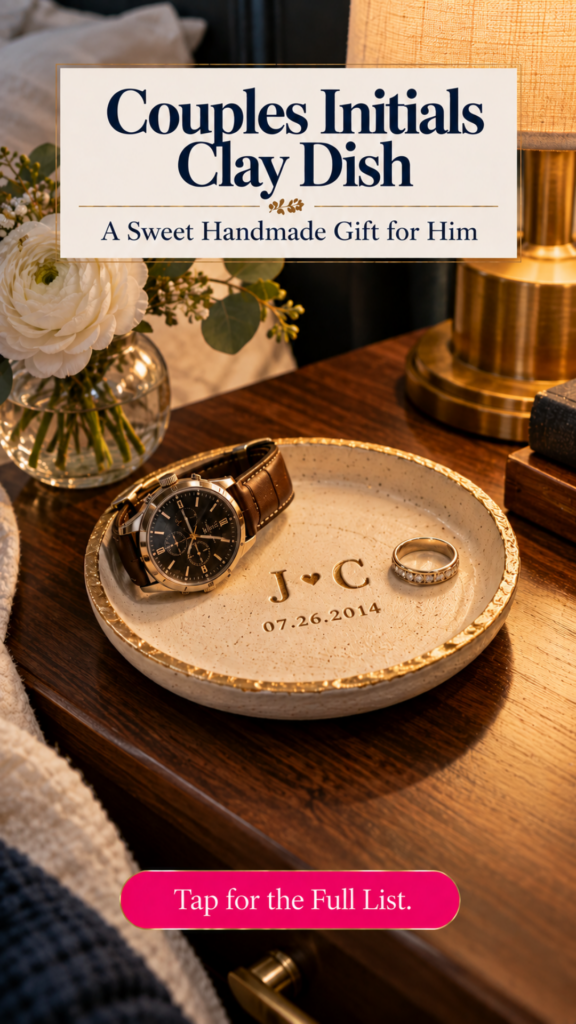 A cream air dry clay trinket dish with a gold rim, stamped with the initials J and C, a heart, and a date, holding a men's watch and a ring on a wooden nightstand. The text reads "Couples Initials Clay Dish, A Sweet Handmade Gift for Him" and "Tap for the Full List." Board: Handmade Gifts for Him