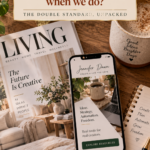 Overhead flatlay of a lifestyle magazine, a smartphone showing a blog homepage, a coffee mug and a notebook on a warm wooden desk, with text overlay reading "Big brands use AI every day — why is it only cheating when we do?"