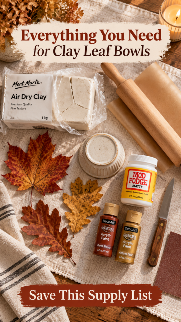 Overhead flat-lay of air dry clay leaf bowl supplies on cream linen — white clay block, wooden rolling pin, parchment paper, small ramekin, paring knife, sandpaper, Mod Podge, rust and gold acrylic paint bottles, and real fall maple and oak leaves.