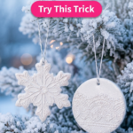 White polymer clay snowflake and round ornaments with pressed vintage lace texture and pearl shimmer, hanging on a frosted evergreen tree.